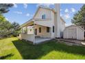 Spacious backyard featuring a covered patio and plenty of green space at 9908 Garfield Ct, Thornton, CO 80229