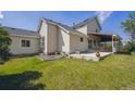 The backyard has a well-maintained lawn and patio, perfect for outdoor entertaining at 9908 Garfield Ct, Thornton, CO 80229