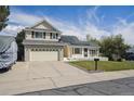 Inviting two-story house featuring a well-maintained lawn and a spacious driveway at 9908 Garfield Ct, Thornton, CO 80229