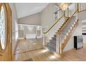 Bright living room with hardwood floors, a grand staircase, and stylish built-in shelving at 5622 E Weaver Cir, Centennial, CO 80111