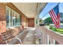 Inviting covered porch with a swing, offering a relaxing outdoor space with view of the yard at 5622 E Weaver Cir, Centennial, CO 80111