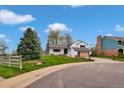Inviting front yard with mature trees and professional landscaping at 10508 W Chautauga Mtn, Littleton, CO 80127