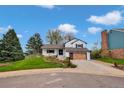 Charming home boasts a well-manicured lawn and modern garage door at 10508 W Chautauga Mtn, Littleton, CO 80127