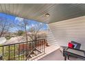 Balcony with railing offers an outdoor space with views of neighborhood homes and trees at 9759 Lane St, Thornton, CO 80260