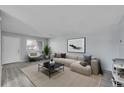 Bright living room with a comfortable neutral-toned couch and stylish black marble coffee table at 9759 Lane St, Thornton, CO 80260