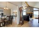 Inviting living spaces featuring wood floors, a fireplace, and vaulted ceilings, creating a warm atmosphere at 32091 Black Widow Dr, Conifer, CO 80433