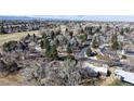 Aerial view of a residential neighborhood with mature trees and a glimpse of a nearby lake at 178 E 11Th Ave, Broomfield, CO 80020