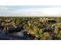 Aerial view of a serene neighborhood, showcasing lush greenery, a tranquil lake, and well-maintained homes at 10158 E Fair Cir, Englewood, CO 80111