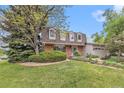 Attractive home exterior showcasing a lush lawn and mature trees at 10158 E Fair Cir, Englewood, CO 80111