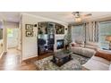 Cozy living room features a fireplace with stone accents, and lots of natural light from the large window at 11895 Hitching Post Ct, Parker, CO 80134