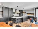 Well-equipped kitchen featuring a large island with bar seating and black cabinets, perfect for entertaining guests at 3910 Reed St, Wheat Ridge, CO 80033