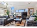 Bright living room with a fireplace, large windows, and modern decor at 7770 S Estes St, Littleton, CO 80128