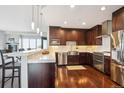 Stylish kitchen boasts stainless steel appliances and modern finishes with hardwood floors at 4875 S Monaco St # 303, Denver, CO 80237
