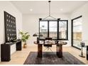 Bright home office with light wood floors, black trim windows and a modern desk and decor at 633 Dexter St, Denver, CO 80220