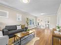 Open-concept living room with hardwood floors, neutral walls, and adjacent dining area at 1987 S Downing St, Denver, CO 80210