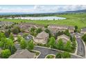 Scenic aerial view of the townhome community near a lake and green open spaces at 12919 W Burgundy Dr, Littleton, CO 80127