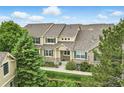 Aerial view showcasing the townhome's well-kept facade with stone accents and blue shutters at 12919 W Burgundy Dr, Littleton, CO 80127
