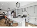 Modern kitchen boasts a large island with seating, stainless steel appliances and stylish pendant lighting at 1286 Raleigh St, Denver, CO 80204