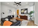 Modern living room with stylish black leather couches, hardwood floors, and unique decor at 1286 Raleigh St, Denver, CO 80204