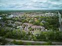 Wide aerial view of a residential area with community pool, lush trees, and well-maintained townhomes at 1441 S Ulster St, Denver, CO 80231