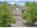Charming home with a well-manicured front yard, a two-car garage, and inviting curb appeal at 1441 S Ulster St, Denver, CO 80231
