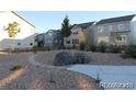Landscaped neighborhood area with native stone, rock ground cover, and sidewalks at 15305 W 93Rd Ave, Arvada, CO 80007