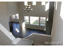 Open foyer boasts soaring ceilings, chandelier, and stairwell at 15305 W 93Rd Ave, Arvada, CO 80007