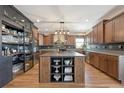 Modern kitchen with custom cabinets, a central island, and stainless steel appliances offers plenty of counter space at 6985 Fallon Cir, Castle Rock, CO 80104