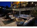 Cozy outdoor patio with a fire pit and comfortable seating for evening gatherings at 6985 Fallon Cir, Castle Rock, CO 80104