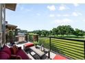 Outdoor balcony with grill and comfortable seating overlooking a golf course at 10243 Spring Green Dr, Englewood, CO 80112