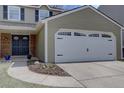 Close up of attached garage with white door and decorative black handles and hinges at 6719 E Costilla Cir, Centennial, CO 80112