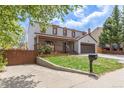 Charming two-story home with a covered front porch, a two-car garage, a well-manicured lawn and a driveway at 4808 S Ward Way, Morrison, CO 80465