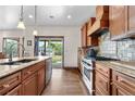 Gourmet kitchen features a spacious island, stainless steel appliances, and custom cabinetry at 1195 W 70Th Ave, Denver, CO 80221