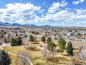 Panoramic view of the neighborhood showcasing the lush landscape, homes, and mountain backdrop at 8815 W Quarto Cir, Littleton, CO 80128