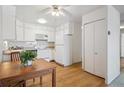 Bright eat-in kitchen features white appliances and wood floors at 655 S Alton Way # 5C, Denver, CO 80247
