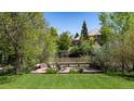 Secluded backyard deck overlooking a pond and lush greenery at 4483 W Cottonwood Pl, Littleton, CO 80123