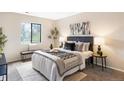 Calm bedroom features a bed, a large window, bench, and tasteful decor at 3600 S Pierce St # 7-201, Denver, CO 80235