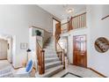 Elegant staircase with wood railings and plush carpeting, bathed in natural light from large windows at 9754 Las Colinas Dr, Lone Tree, CO 80124