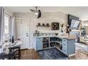 Stylish wet bar with custom cabinets, wine storage, beverage refrigerator, and seating area for entertaining at 4063 S Quintero Way, Aurora, CO 80013