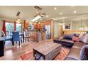 Open-concept living room with hardwood floors, natural light, and comfortable seating at 30273 Conifer Rd, Evergreen, CO 80439