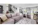 Open-concept living room with gray-toned walls, hardwood floors and modern staircase at 2399 E 99Th Way, Thornton, CO 80229