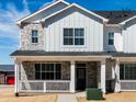 Beautiful home exterior with stone accents, white siding, and a covered front porch entrance at 6531 N Malaya St, Aurora, CO 80019