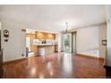 Bright dining area featuring hardwood floors, chandelier lighting, and sliding glass doors to the backyard at 8552 Gray Ct, Arvada, CO 80003
