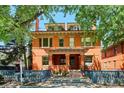 Beautiful red brick home with a covered porch and inviting curb appeal on a sunny day at 1401 N Franklin St # 1, Denver, CO 80218