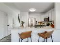 Kitchen with a breakfast bar, stainless steel appliances, and a staircase view at 2642 Devonshire Ct, Denver, CO 80229