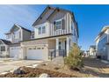 Two-story home with gray siding, white trim, and a two-car garage at 6585 N Nepal St, Aurora, CO 80019