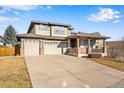 Two-story house with attached two-car garage and landscaped front yard at 13676 Cherry Way, Thornton, CO 80602