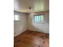 Bedroom with wood floor, natural lighting from two windows, and neutral walls at 8250 Ralph Ln, Denver, CO 80221