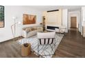 Cozy living room with hardwood floors, modern fireplace, stylish decor, and neutral color palette at 2522 Zenobia St, Denver, CO 80212