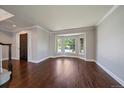 Spacious living room with hardwood floors, bay window and a dark wooden front door at 11506 Greenbriar Ln, Parker, CO 80138